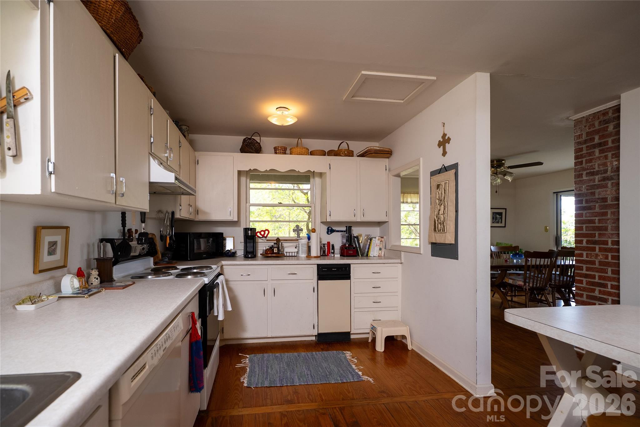 1412 North Bearwallow Road Fletcher, NC 28732 - Photo 16 of 30 a kitchen filled with white cabinets and appliances