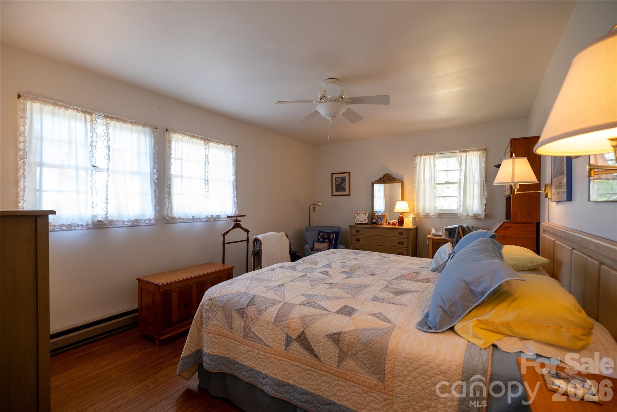 1412 North Bearwallow Road Fletcher, NC 28732 - Photo 19 of 30 a bedroom with a bed and wooden floor