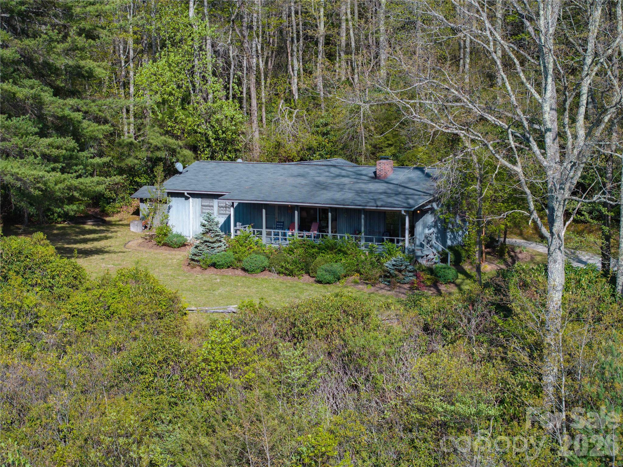1412 North Bearwallow Road Fletcher, NC 28732 - Photo 5 of 30 a view of a house with a yard and sitting area