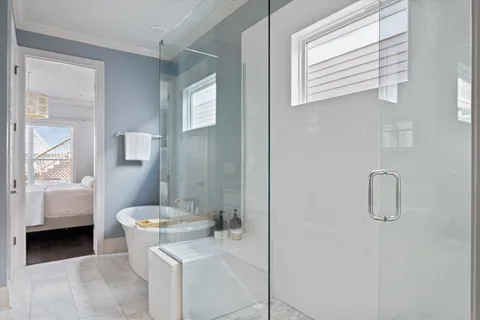 a bedroom with a bed and a large window