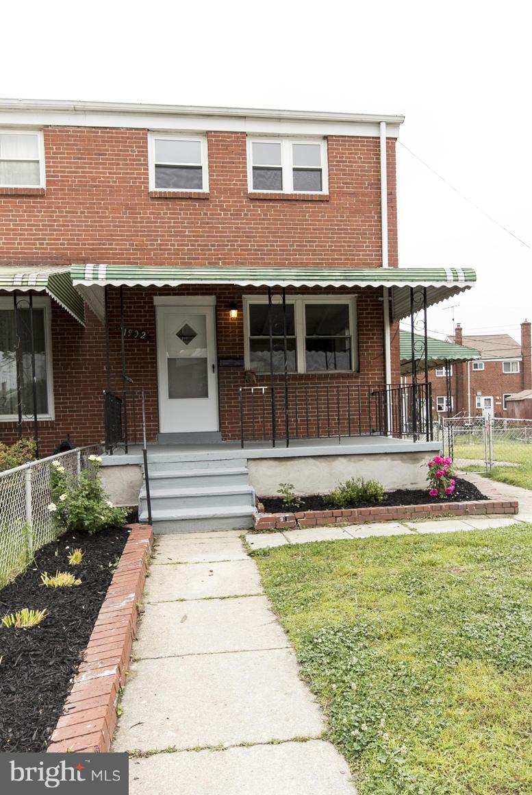 1902 Jasmine Road Baltimore, MD 21222 - Photo 1 of 27 a front view of a house with a yard