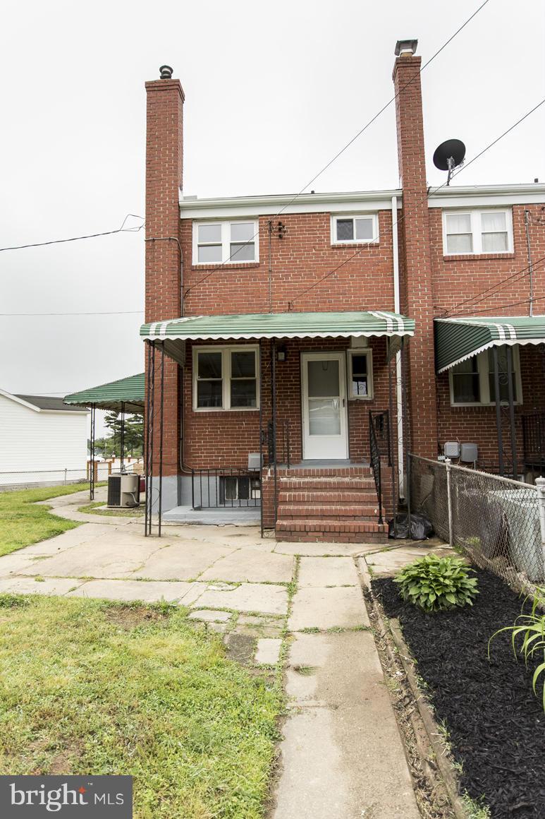1902 Jasmine Road Baltimore, MD 21222 - Photo 3 of 27 a front view of a house with a yard