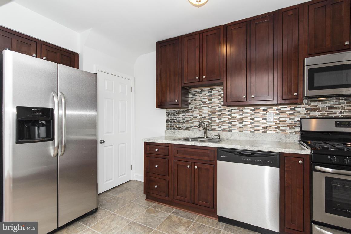 1902 Jasmine Road Baltimore, MD 21222 - Photo 6 of 27 a kitchen with stainless steel appliances granite countertop a refrigerator and a sink