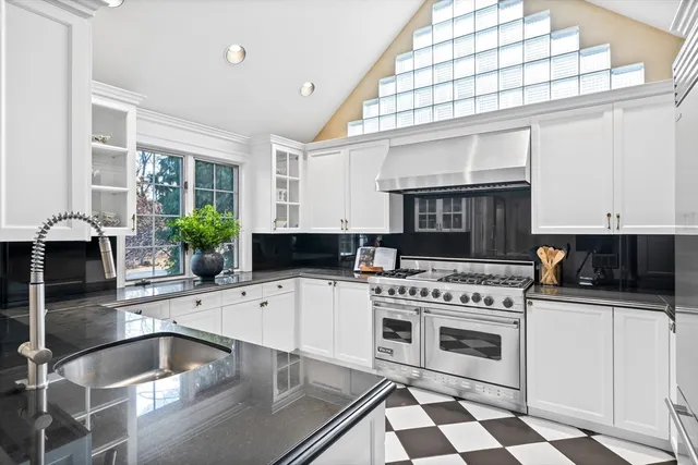 a kitchen with a stove a sink and a microwave