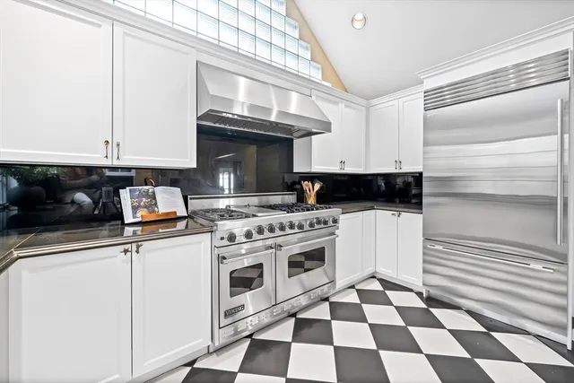 a kitchen with a stove a sink and a refrigerator