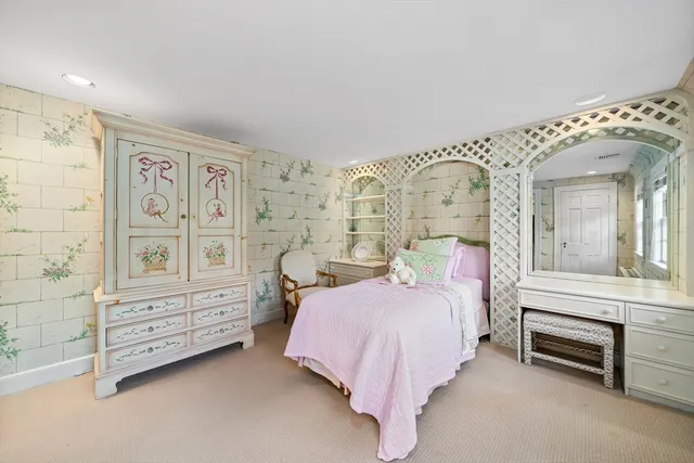 a spacious bedroom with a bed and a cabinets