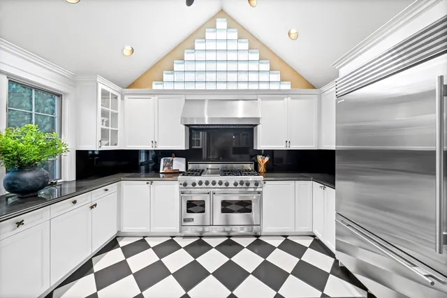 a kitchen with a stove a sink and a window