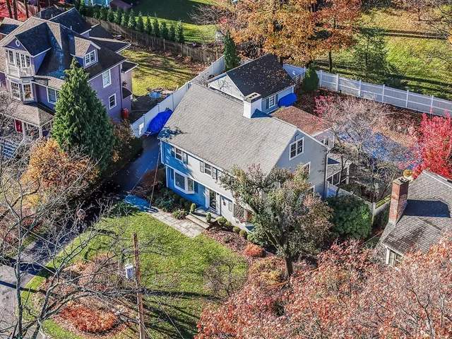 an aerial view of a house with a yard
