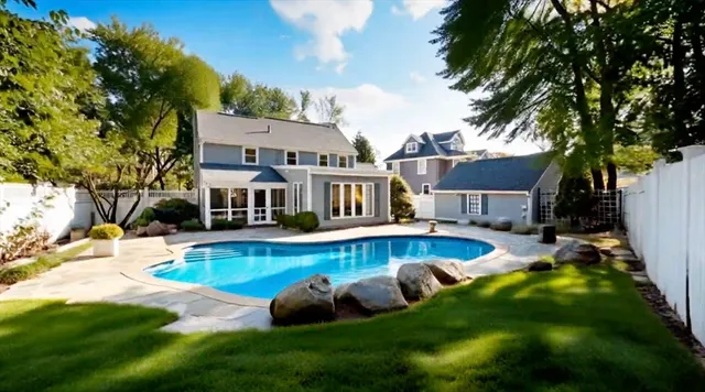 a view of a house with swimming pool and sitting area