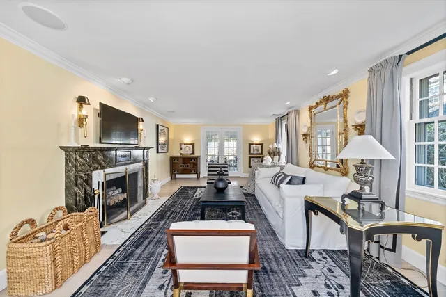 a living room with furniture fireplace and flat screen tv