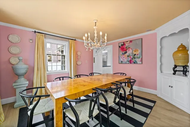a view of a dining room with furniture and chandelier