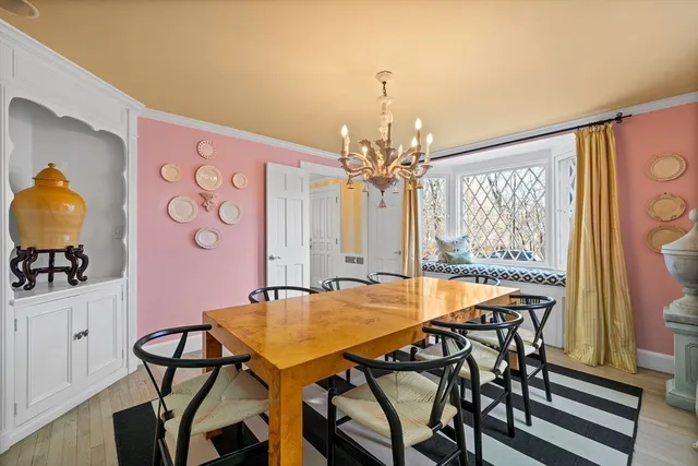 a view of a dining room with furniture and chandelier