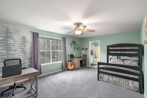 a living room with furniture and a piano