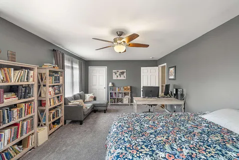 a living room with furniture and a book shelf