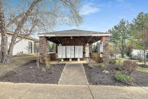 a view of a patio with a table and chairs under an umbrella