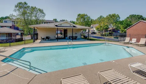 a view of a house with swimming pool and sitting area