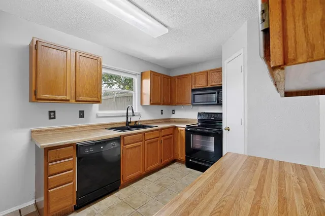 a kitchen with stainless steel appliances granite countertop a sink and stove top oven