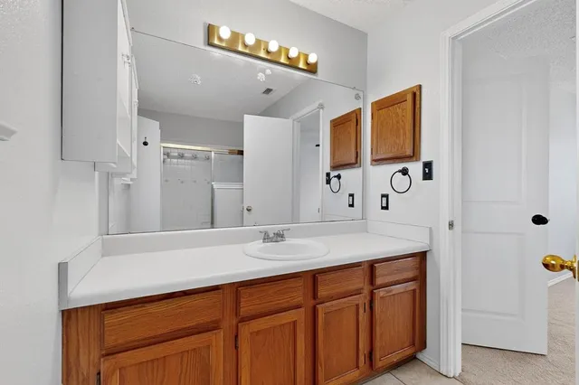 a bathroom with a sink vanity and mirror