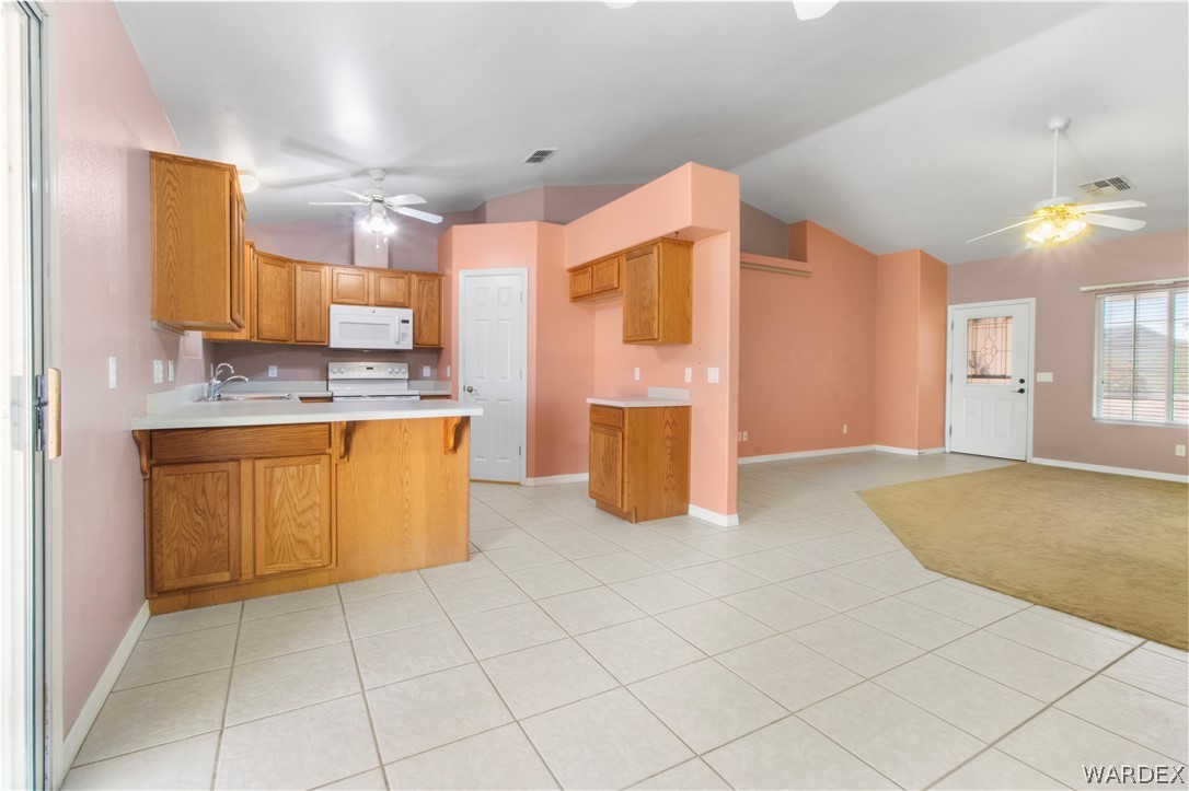 2158 Ranch Road Kingman, AZ 86401 - Photo 11 of 48 a kitchen with stainless steel appliances granite countertop a stove a sink and a refrigerator