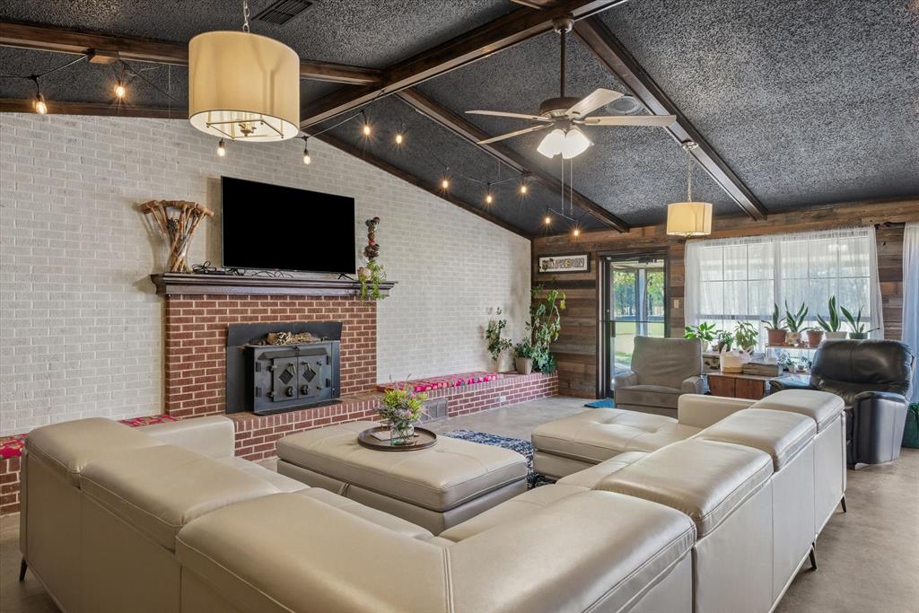 11571 Highway 19 Canton, TX 75103 - Photo 26 of 38 a living room with furniture a fireplace and a flat screen tv