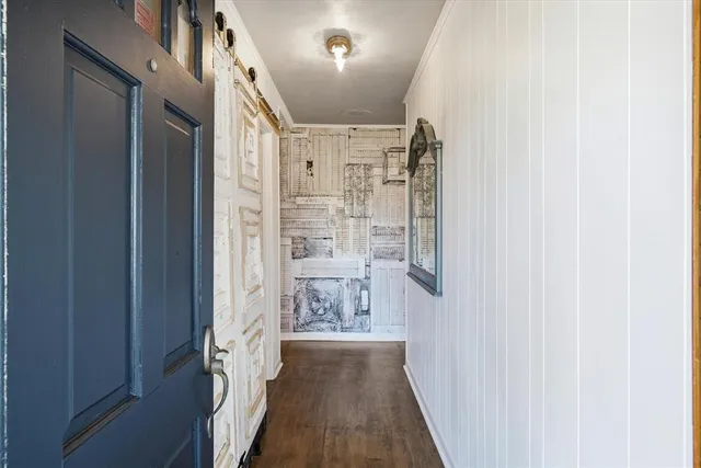 a view of hallway with wooden floor