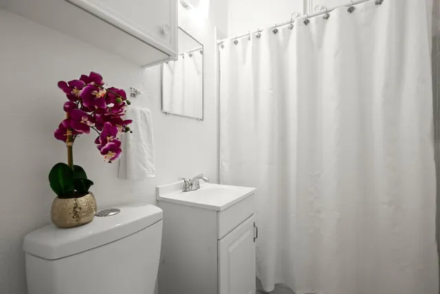 a bathroom with a sink toilet and shower