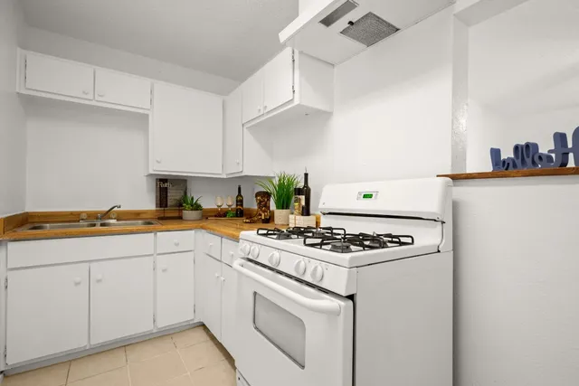 a kitchen with cabinets and white appliances