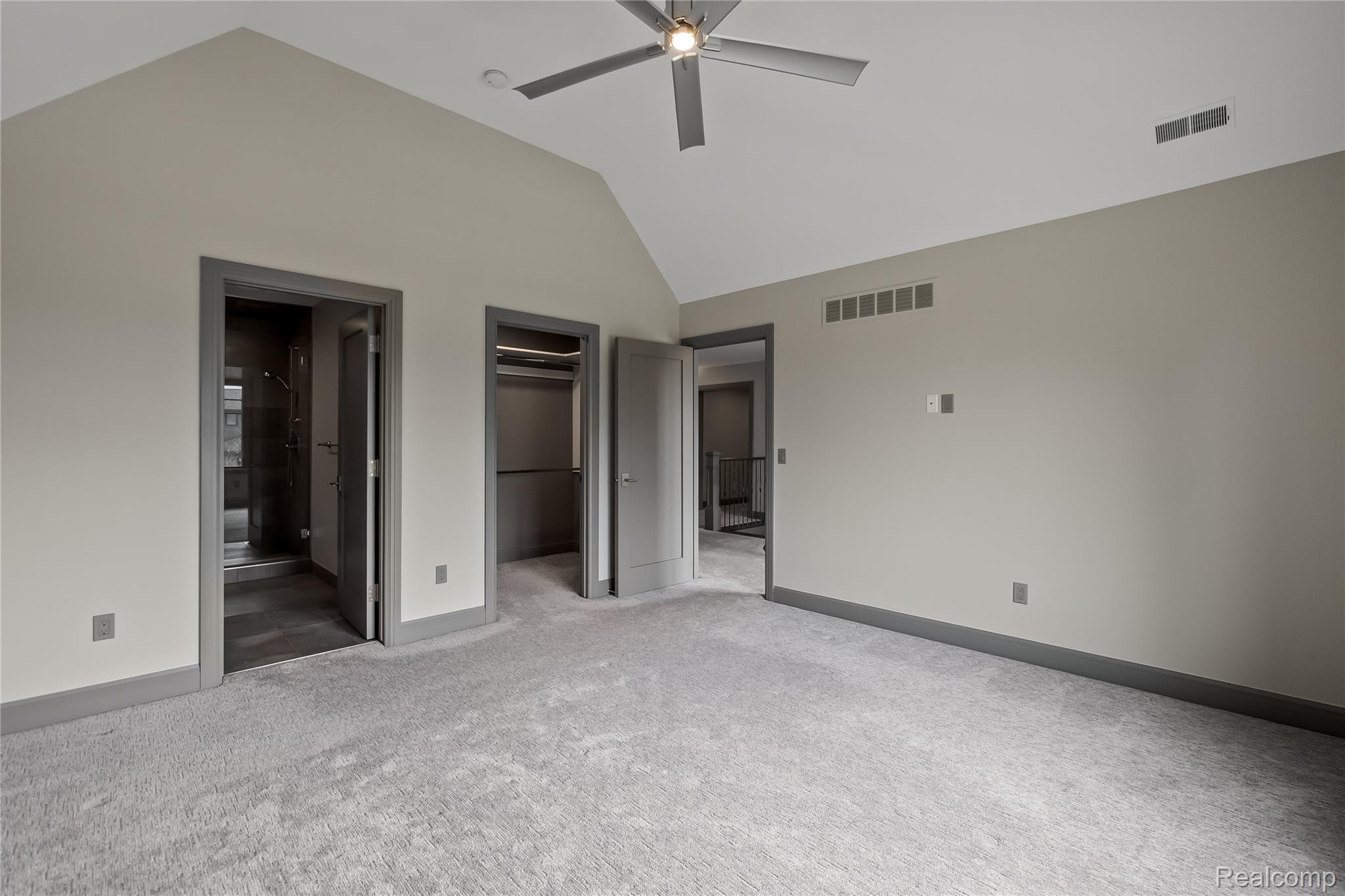 3824 Poppleton Street Troy, MI 48084 - Photo 27 of 51 Unfurnished bedroom featuring ensuite bath, a walk in closet, lofted ceiling, carpet floors, and ceiling fan
