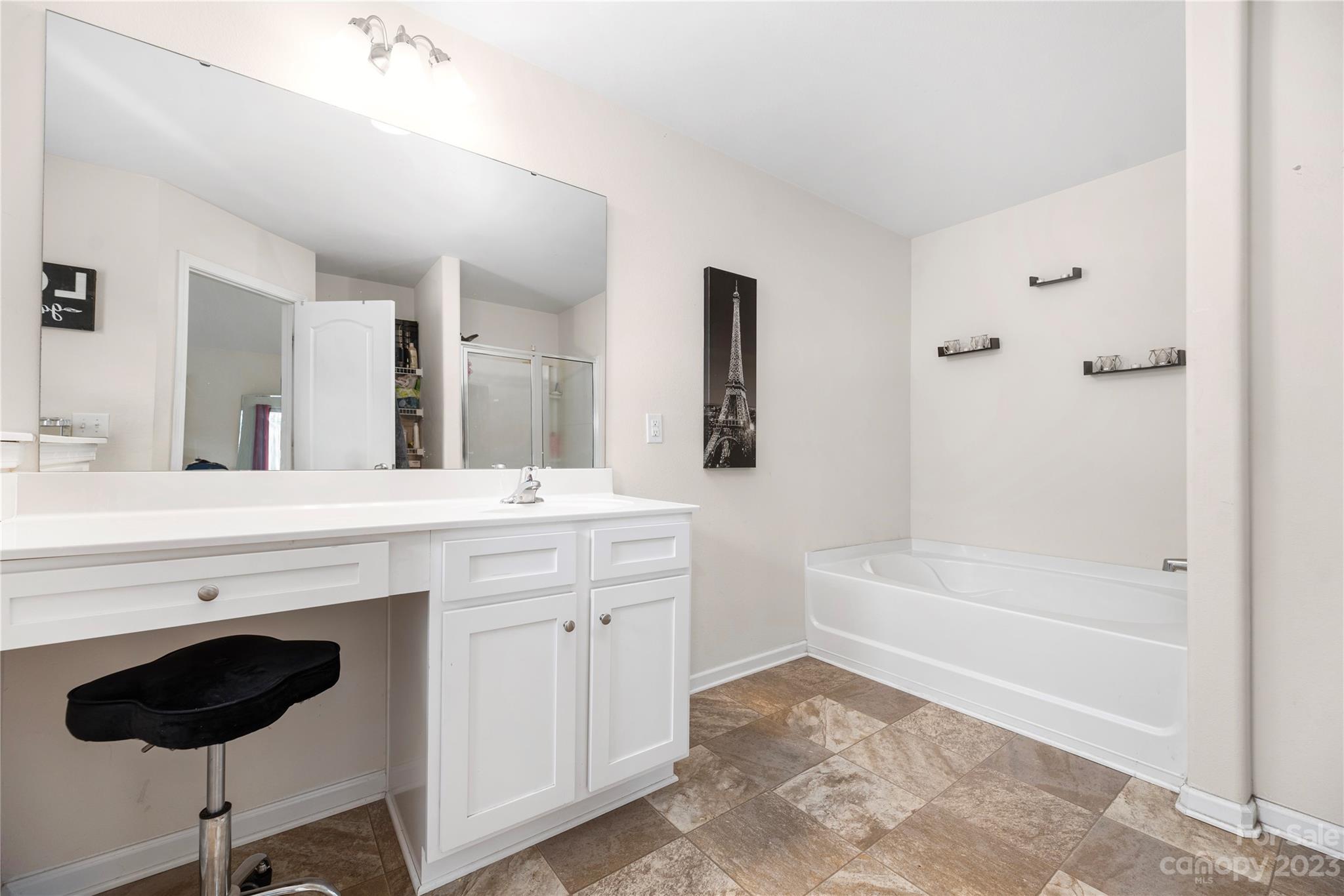6415 Jerimoth Charlotte, NC 28215 - Photo 15 of 22 a spacious bathroom with a granite countertop sink a toilet mirror and bathtub