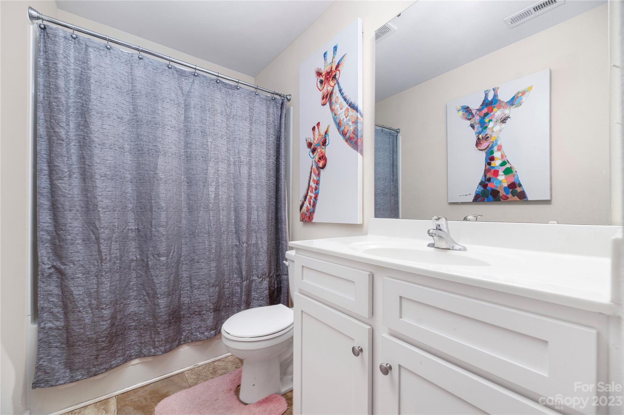 6415 Jerimoth Charlotte, NC 28215 - Photo 18 of 22 a bathroom with a sink a toilet and a shower curtain