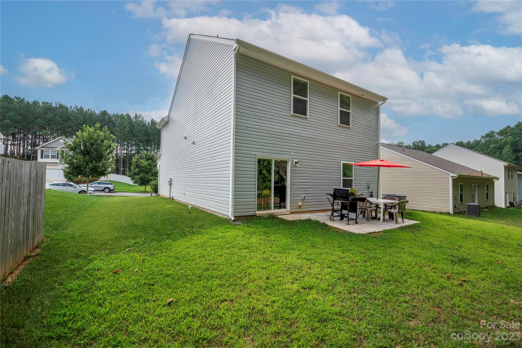 6415 Jerimoth Charlotte, NC 28215 - Photo 19 of 22 a view of a backyard with table and chairs and a yard