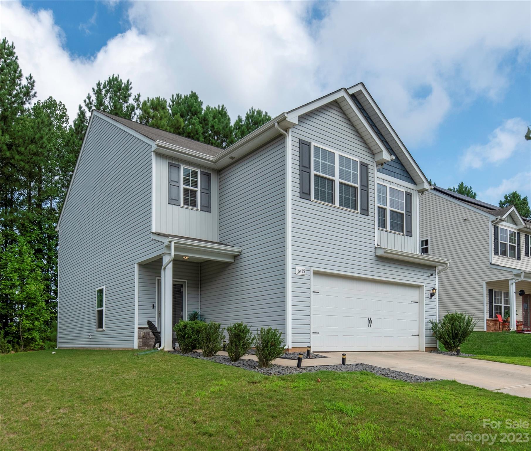 6415 Jerimoth Charlotte, NC 28215 - Photo 2 of 22 a front view of a house with a yard and garage