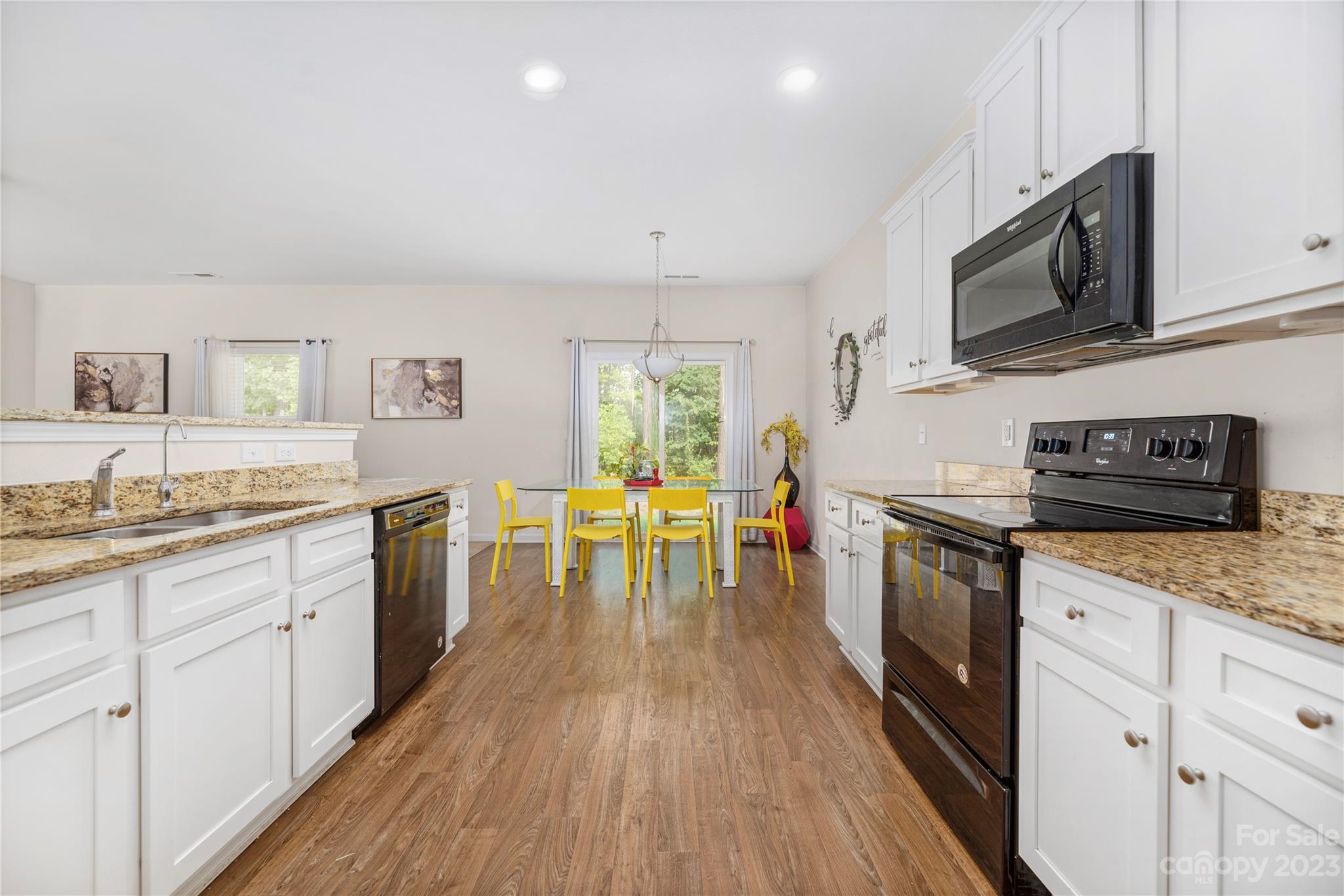6415 Jerimoth Charlotte, NC 28215 - Photo 10 of 22 a kitchen with stainless steel appliances granite countertop wooden cabinets a stove top oven a sink and dishwasher