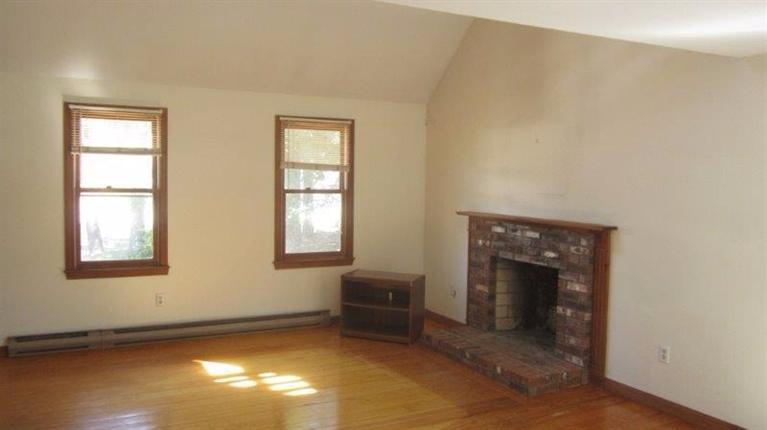 315 Hay Road Eastham, MA 02642 - Photo 8 of 14 a view of an empty room with a window and fire place