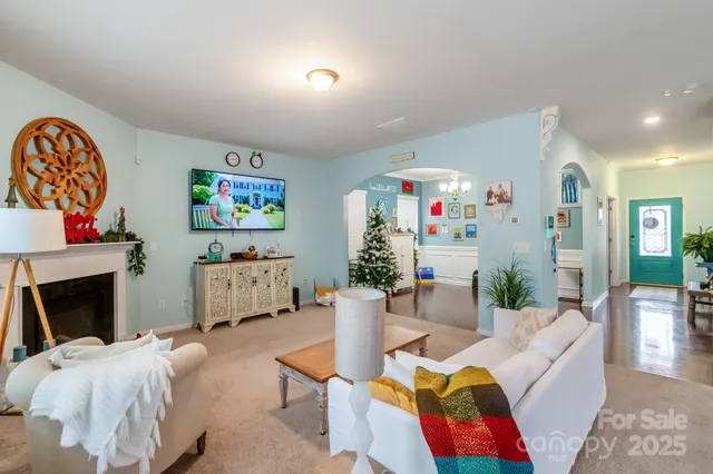 a kitchen with stainless steel appliances kitchen island granite countertop a table chairs and a refrigerator