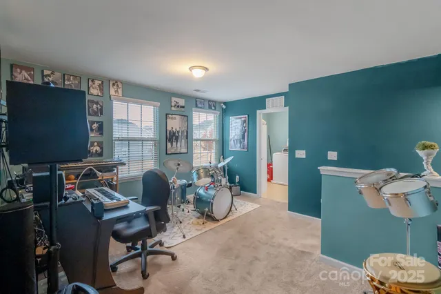 a view of a livingroom with workspace and a window