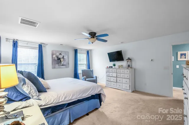 a view of walk in closet with clothes