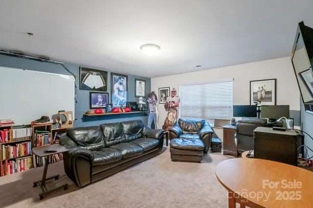 a bedroom with bed and a flat tv screen on dresser