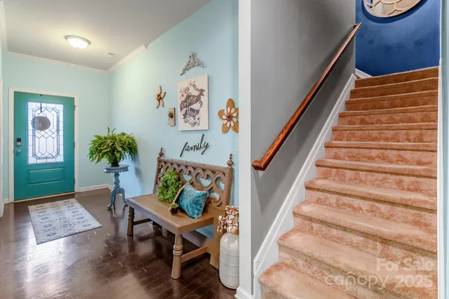 a view of entryway with stairs and wooden floor
