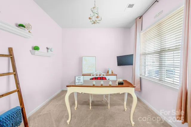 a dining room with furniture and window
