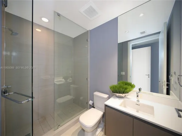 a bathroom with a sink toilet and shower