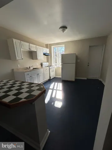 a kitchen with a stove and a refrigerator