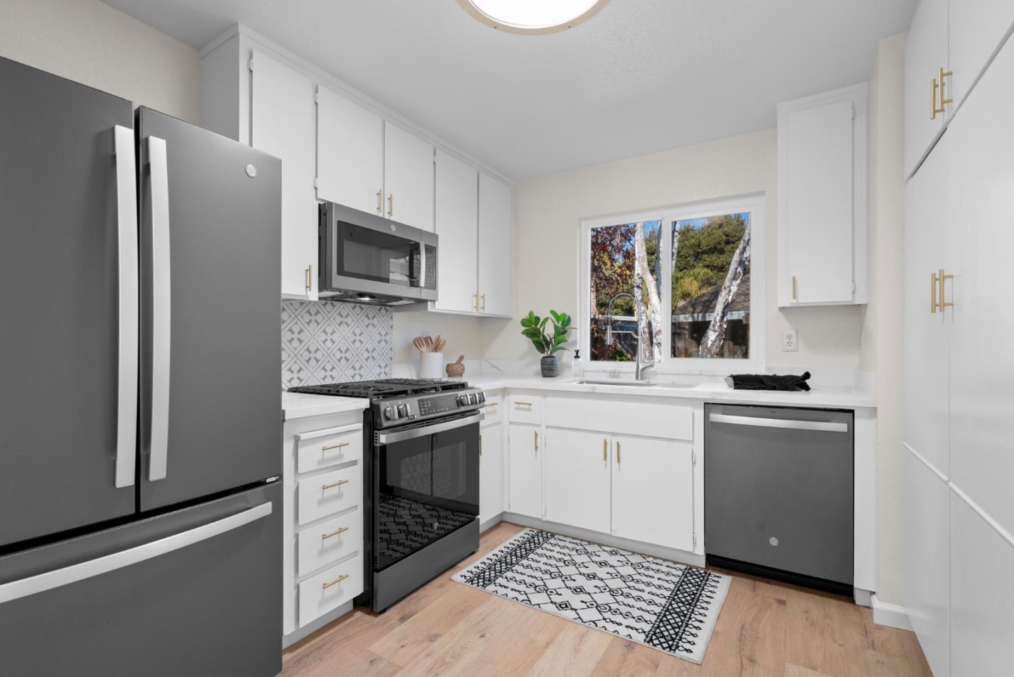 443 Sailfish Drive Aptos, CA 95003 - Photo 17 of 60 a kitchen with granite countertop stainless steel appliances a sink stove and refrigerator