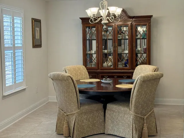 a dining room with furniture and window