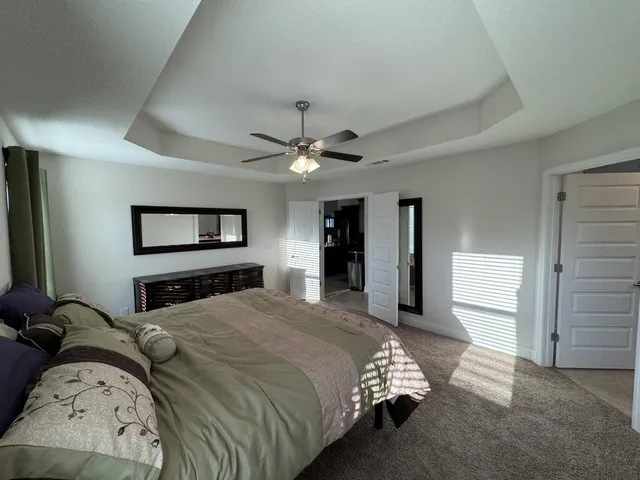 a bedroom with bed and a chandelier