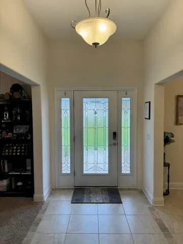 a view of an entryway with a cabinet and a window