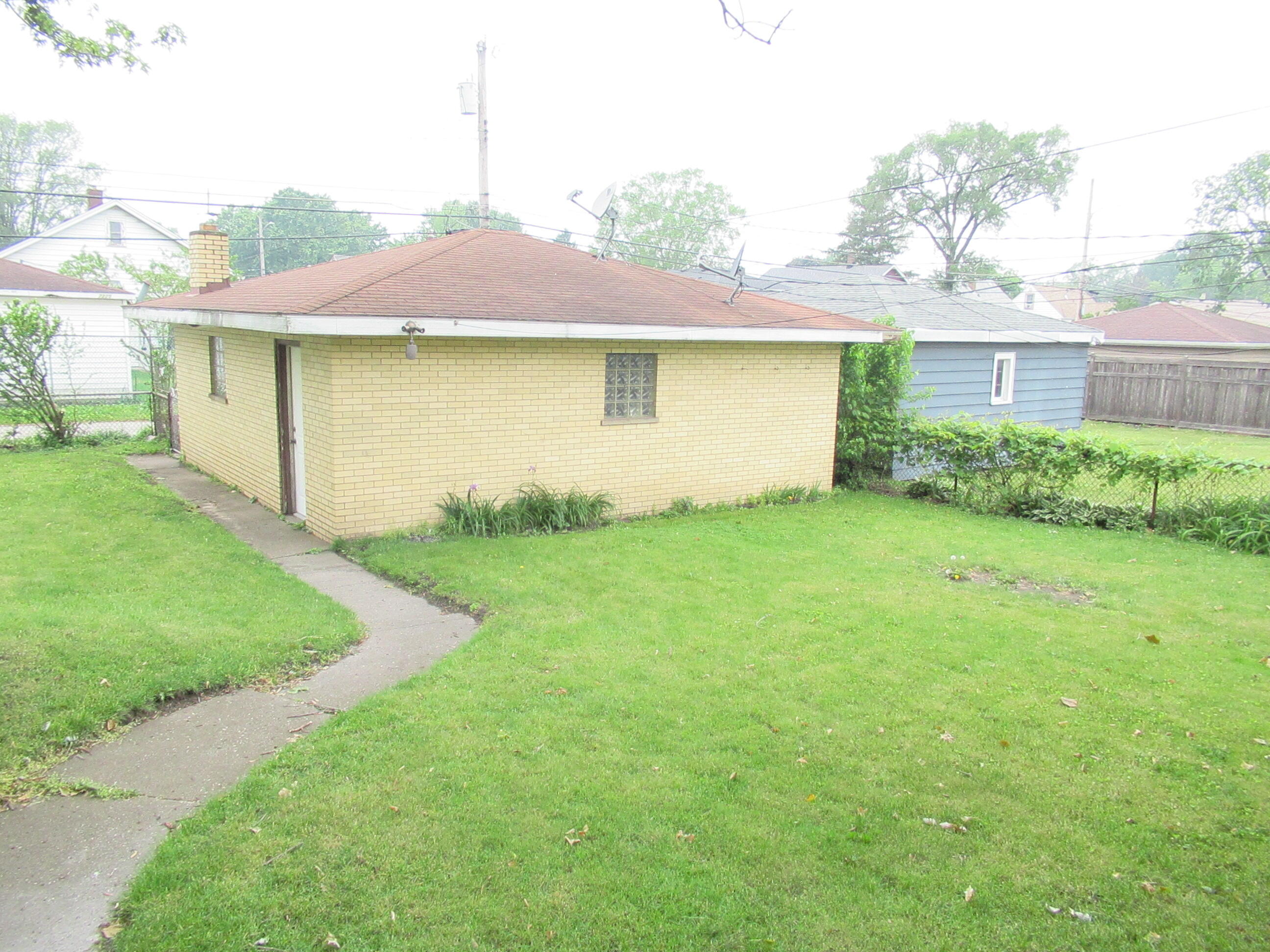 7230 Beech Avenue Hammond, IN 46324 - Photo 12 of 13 a view of a house with a yard and a large tree