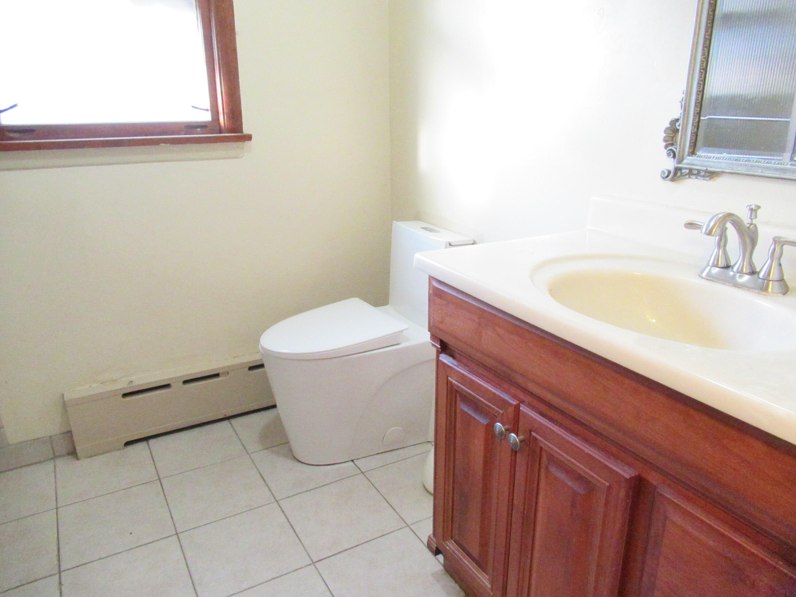 7230 Beech Avenue Hammond, IN 46324 - Photo 8 of 13 a bathroom with a sink a toilet and mirror