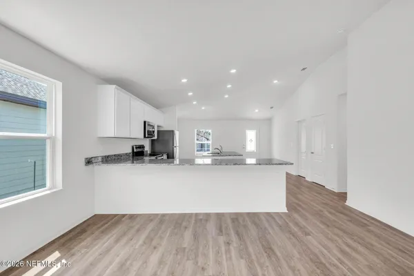 a view of kitchen with wooden floor