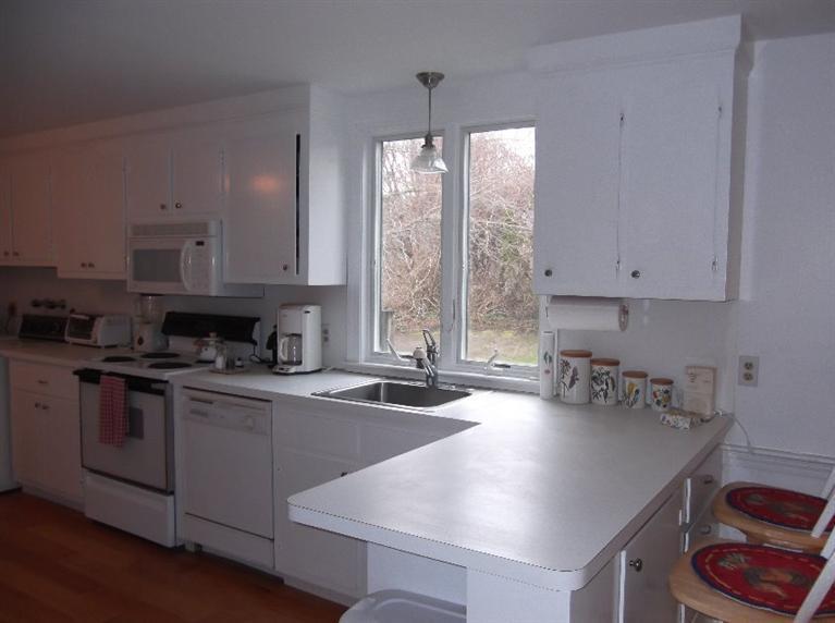 30 Twiss Road Orleans, MA 02653 - Photo 16 of 29 a kitchen with stainless steel appliances granite countertop a stove a sink and a refrigerator